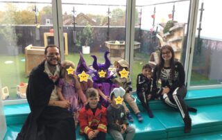 staff and children in halloween costumes