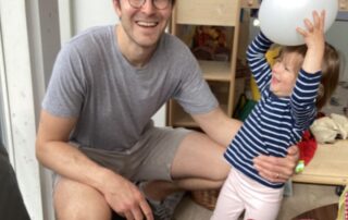Dad and child playing with balloons