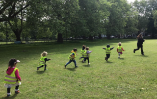 Nursery children running in the fields and grass
